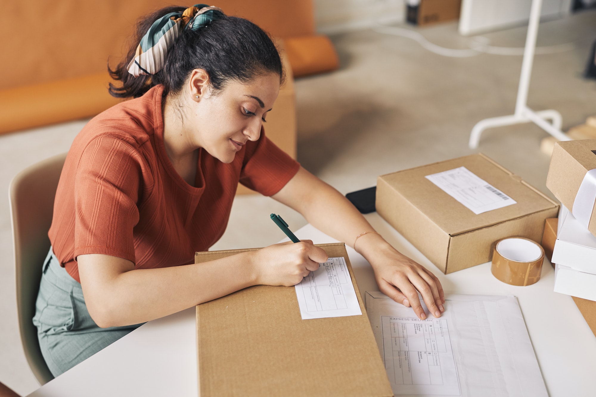 Woman signing the box before shipping